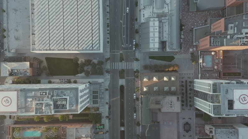 Breathtaking Overhead Birds Eye View of Downtown Los Angeles California in beautiful Sunset Light with view of Building Rooftops and Car traffic passing