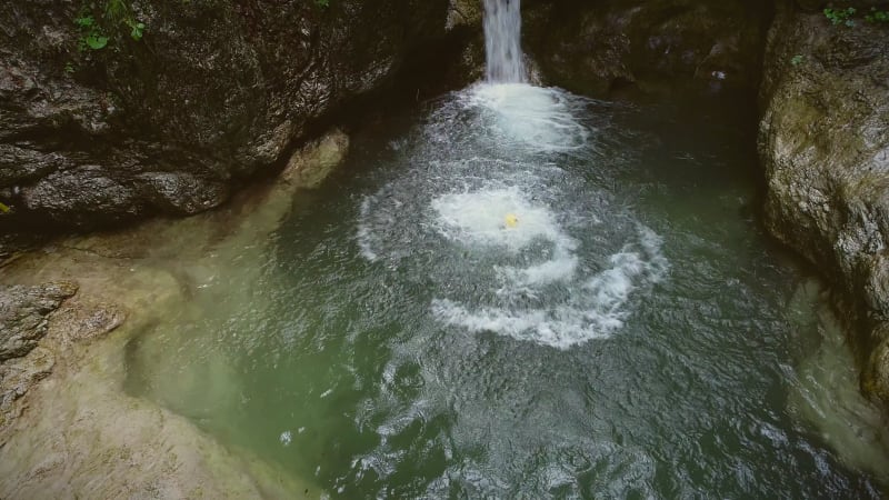 Aerial view of child jumping into the water.