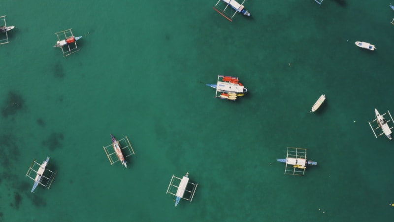 Aerial view of boats on turquoise water in El Nido, Palawan.