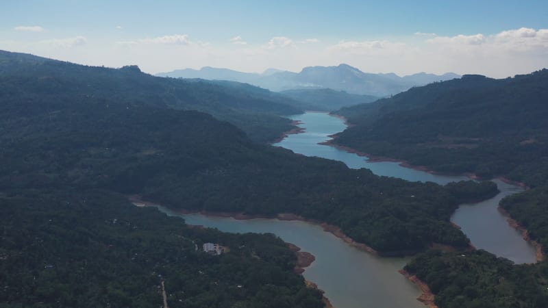 Aerial view of a river crossing the forest in Nuwara Eliya, Sri Lanka.