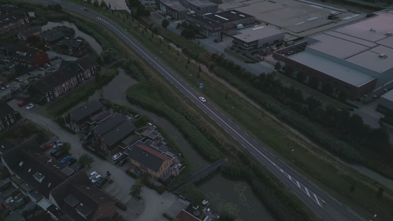 Evening Aerial View of a car driving next to the village Houten, Netherlands