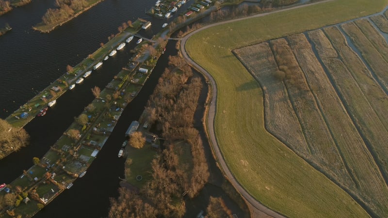 Aerial view of houses with boats on the lake.