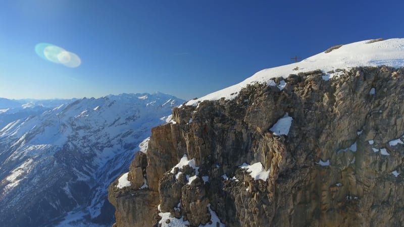 Mountain Peak and Steep Snowy Valley