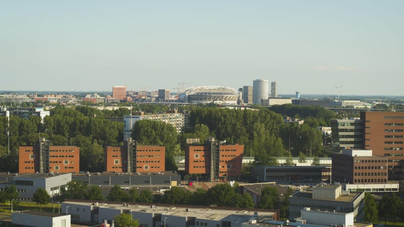 Residential and industrial buildings with sports arena in the background