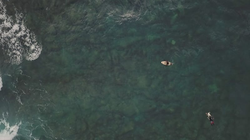 Aerial view of a man surfing at an agitated sea near Lošinj coastline.