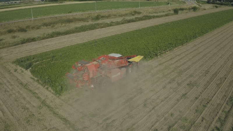 In August 2022, an aerial view captured a farmer harvesting potatoes amidst a drought in the Netherlands.