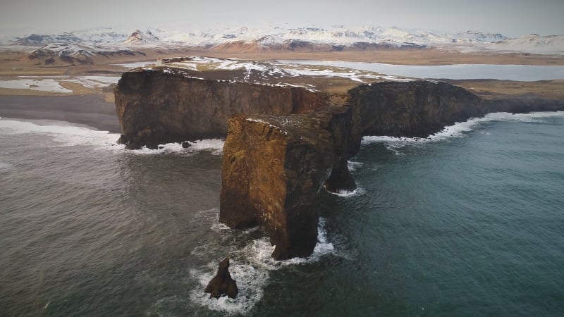 Aerial view of Dyrhólaey peninsula with the black arch of lava.