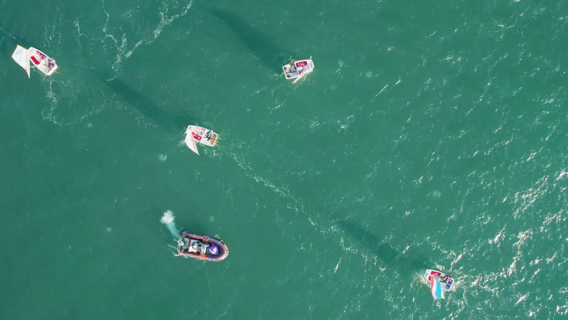 Aerial view of sailing boats navigating near Acre Old City port in Israel.