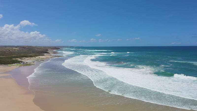 Aerial view of sandy beaches and waves.