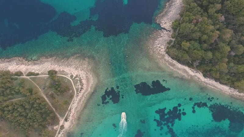 Aerial view of boat sailing at strait between Koludarc island.