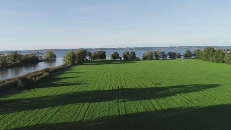 Aerial view of people riding a bike in a field, Lake Constance, Switzerland.