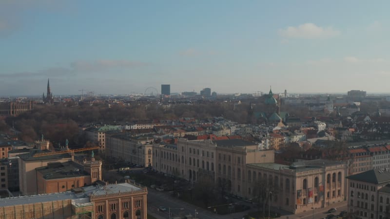 Towards St. Lukas Church Cathedral with Green Roof towers in beautiful Munich, Germany, Aerial dolly in