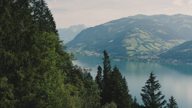 Reveal of a stunning blue lake in an alpine valley