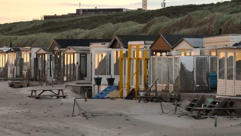 Beach houses that were blown over with sand during the storm of Poly at Wijk Aan Zee, the Netherlands