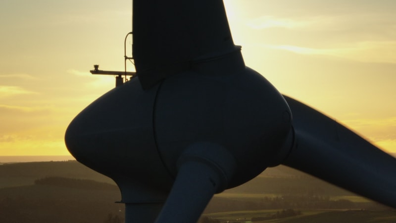 Wind Turbine Silhouette at Sunset Generating Renewable Energy