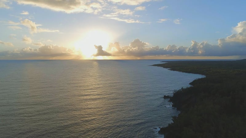 Sunrise Over A Picturesque Coastline with the Sun Rising Over the Sea