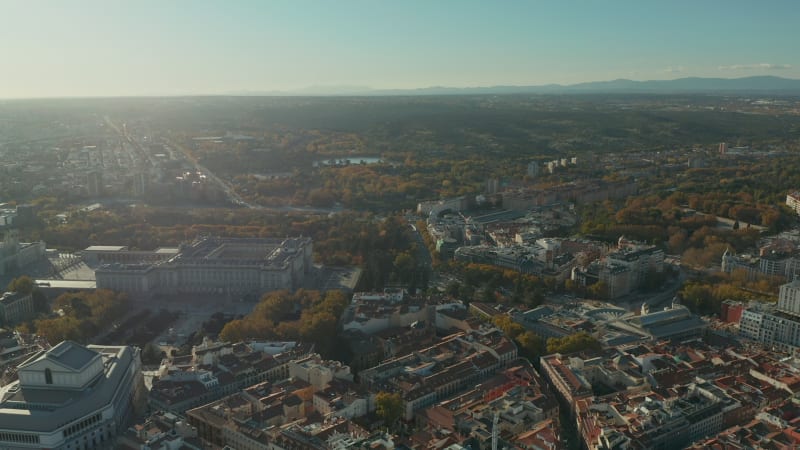 Forwards fly above historic part of city with landmarks. Royal Theatre and  Royal Palace complex.