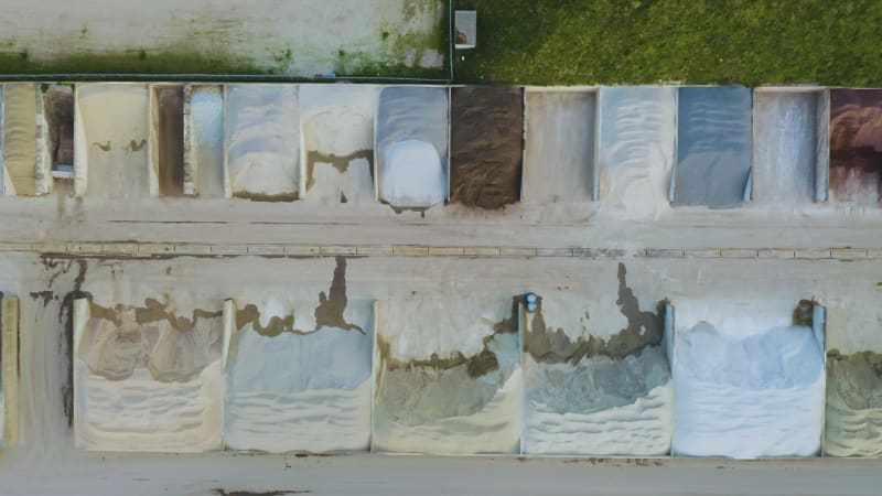 Top view flying over different gravel mounds at a quarry