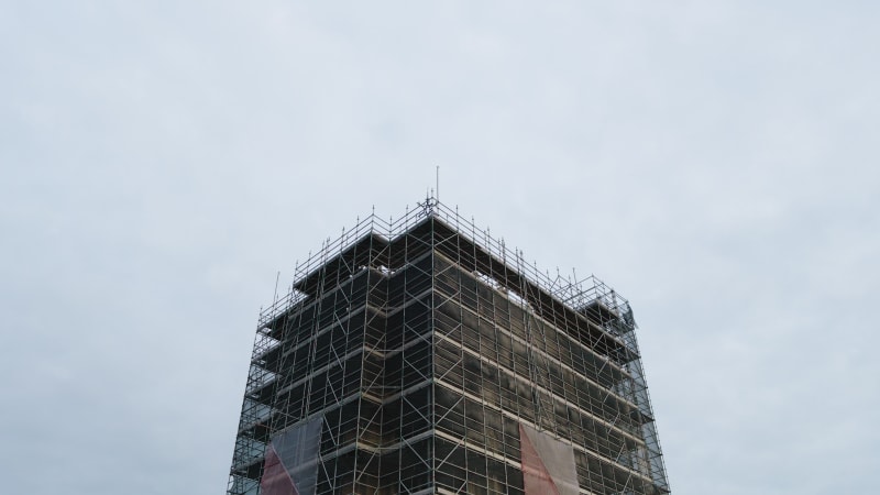 An aerial perspective captures the maintenance and restoration scaffolding the majestic Dom tower in the historic city of Utrecht.