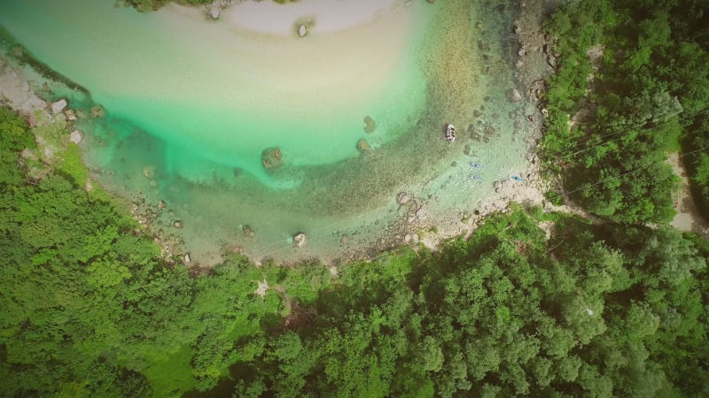 Aerial view of people doing rafting surrounded by nature.