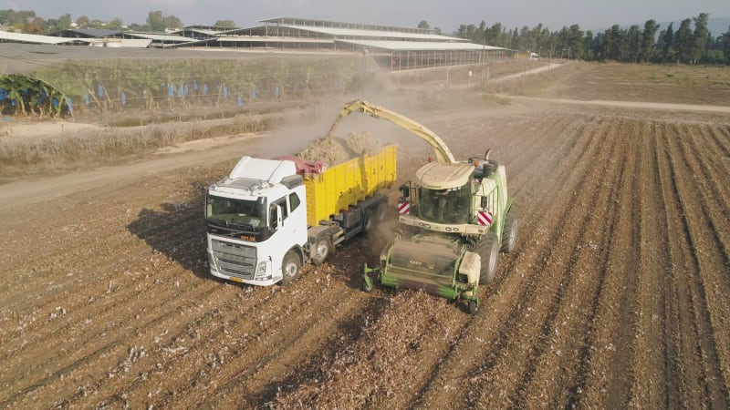 Aerial view of a tractor and a lorry working in a field, Kibbutz Saar, Israel.