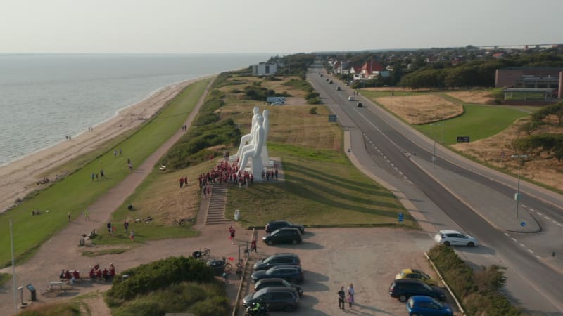 Aerial view of Esbjerg seaside, with slow camera rotation around Man Meets the Sea sculpture. High Angle view of the  famous sculpture od  with lots of turists visiting. Esbjerg, Denmark