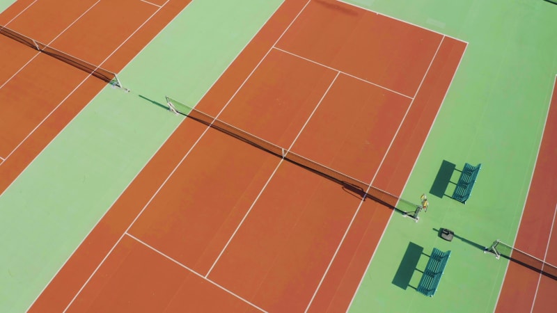 Rising aerial shot of an empty tennis court