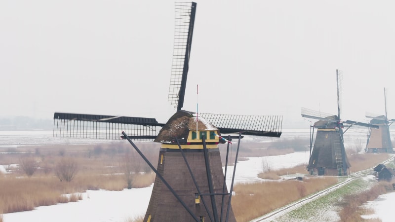 Circling a Spinning Windmill In Snowy Winter