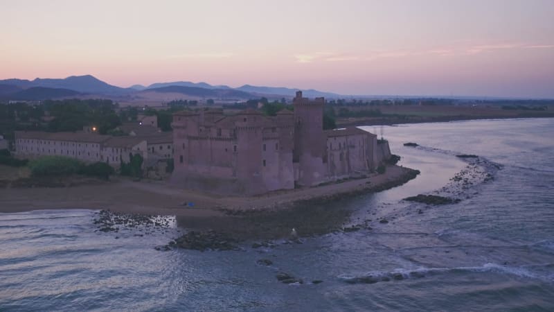 Santa Severa Beach and Castle at sunrise, Province of Rome, Italy. Aerial drone view