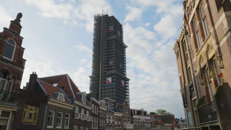 An aerial perspective captures the maintenance and restoration scaffolding the majestic Dom tower in the historic city of Utrecht.