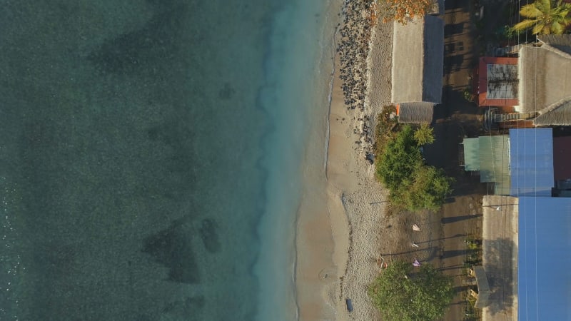 Bird's Eye View of a Picturesque Sandy Beach and Coast With Moored Fishing Boats