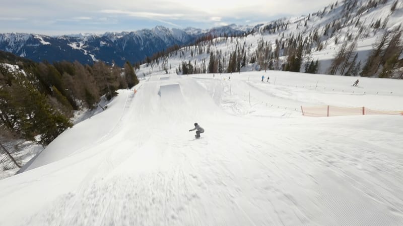 Junior Snowboarder's Aerial Jump in Flachau Funpark