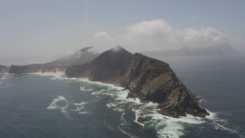 The tip of Africa Cape Point peninsula with steep cliffs surrounded by ocean