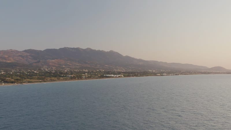 Soft light on a Greek shore in the distance panning toward the ocean