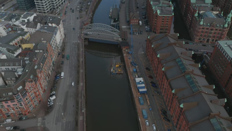 Pedestrians and cars driving on the streets by the canals of Elbe river in Hamburg city center