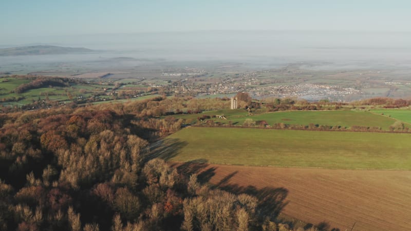 Broadway Tower, a famous iconic tourist attraction in The Cotswolds Hills, iconic English landmark with beautiful British countryside scenery in mist, Gloucestershire, England, UK