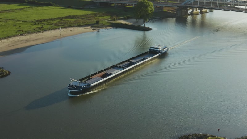 Tracking a cargo ship from above as it sails the river