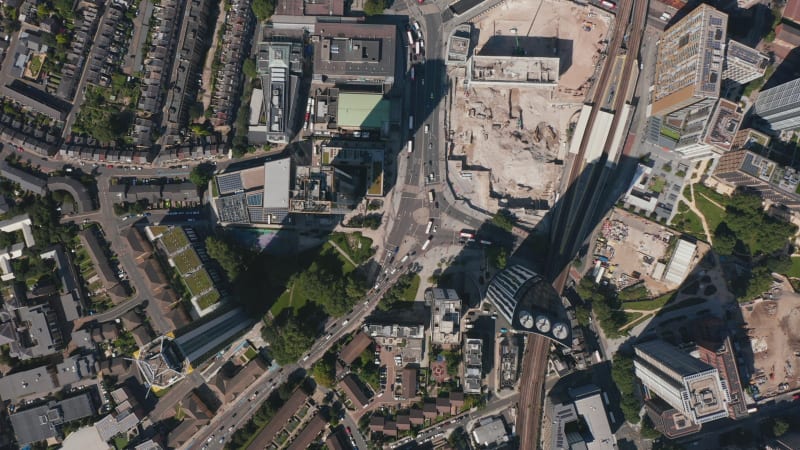 Aerial birds eye overhead top down view of stream of cars and buses driving through road intersection at Elephant and Castle. London, UK