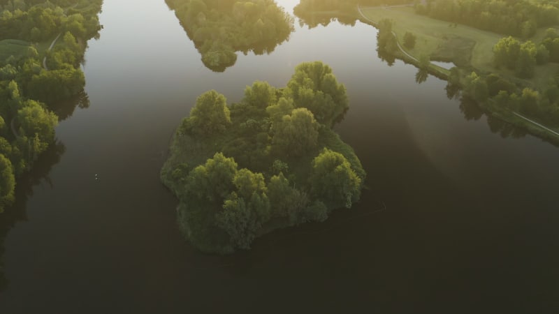 Top down view of a stunning island on the lake in golden sun light