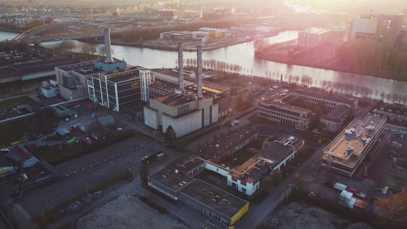 Aerial view of a factory with rooftop chimneys on a sunny day in Utrecht, Netherlands.