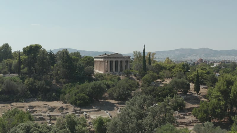 Slow Aerial Dolly movement towards typical Greek temple ruins in Athens, Greece at Daylight