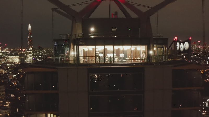 Pull back footage of top of modern high rise building at Elephant and Castle. Night downtown panorama. London, UK