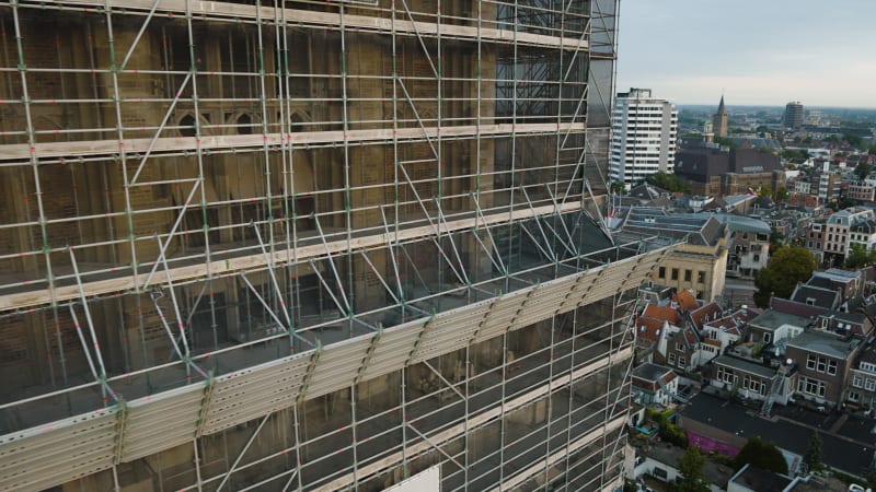 An aerial perspective captures the maintenance and restoration scaffolding the majestic Dom tower in the historic city of Utrecht.