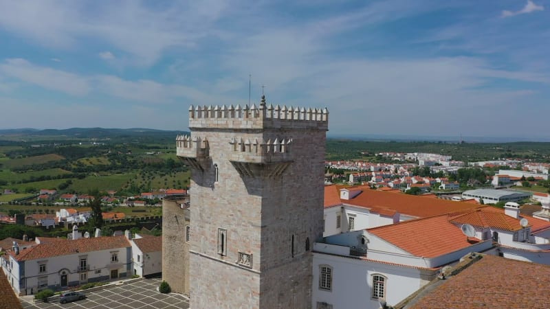 Aerial view of fortified village on hill.