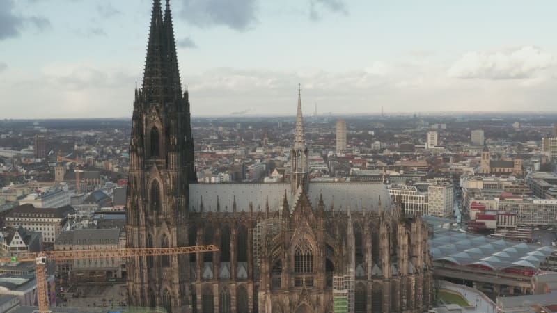 Backwards reveal of Cathedral Church of Saint Peter. Aerial view of historic gothic Christian landmark. Cologne, Germany