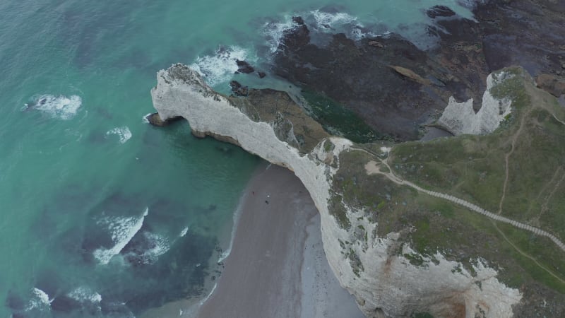 Wide Establishing Shot of Cliff Shoreline and Rough Ocean Waves, Etretat Cliffs in France