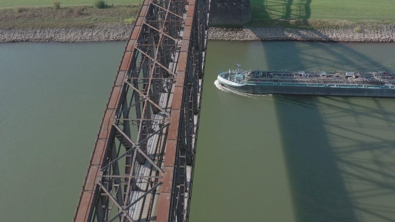 Bulk Carrier Cargo Ship Passing Under An Old Iron Bridge