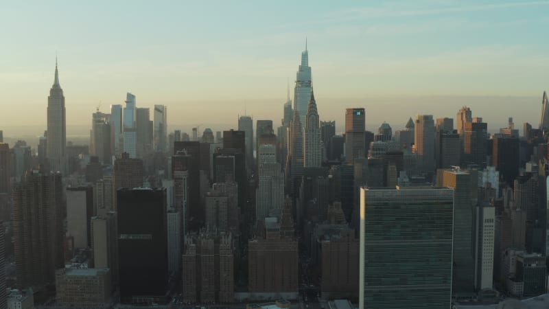 City at sunset. Various tall office of apartment buildings in midtown against colourful sky. Manhattan, New York City, USA