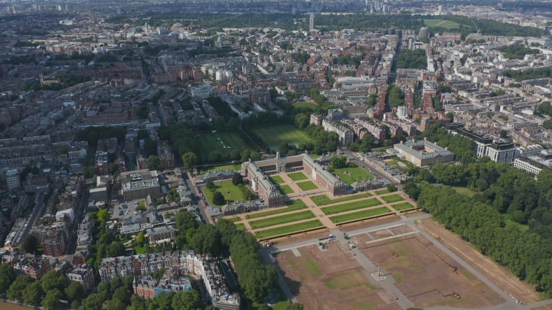 Slide and pan footage of historic buildings of Royal Hospital Chelsea and surrounding parks and gardens. Aerial panoramic view of urban district. London, UK