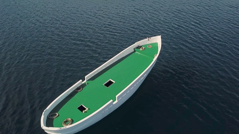 Aerial view of unfinished boat anchored alone at Adriatic sea.